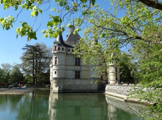 The small turrets of Chateau de Azay-le-Pideau suspended over the water of the river Indre