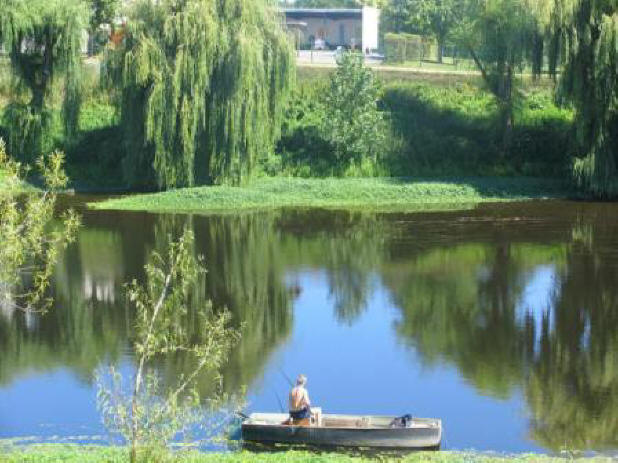 man fishing from a boat on a river in the Loire Valley